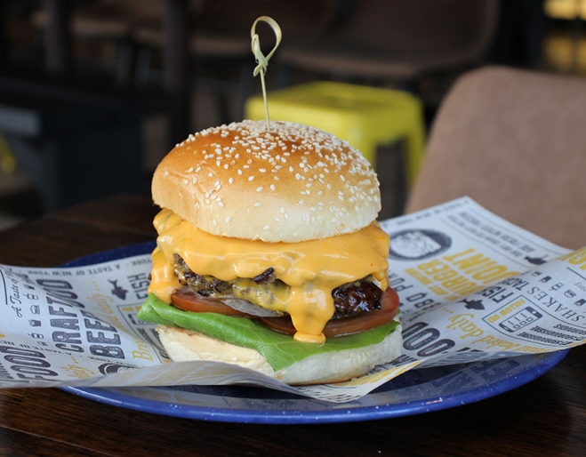 Burger on a plate at 5 Boroughs Rosalie