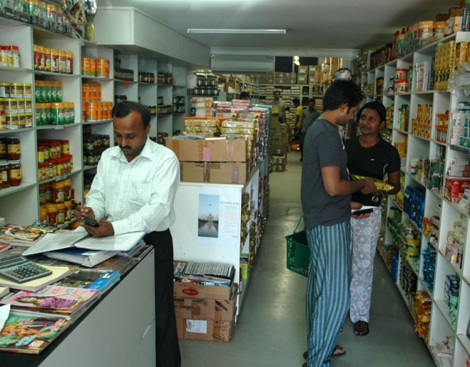 People shoping inside All India Foods supermarket.