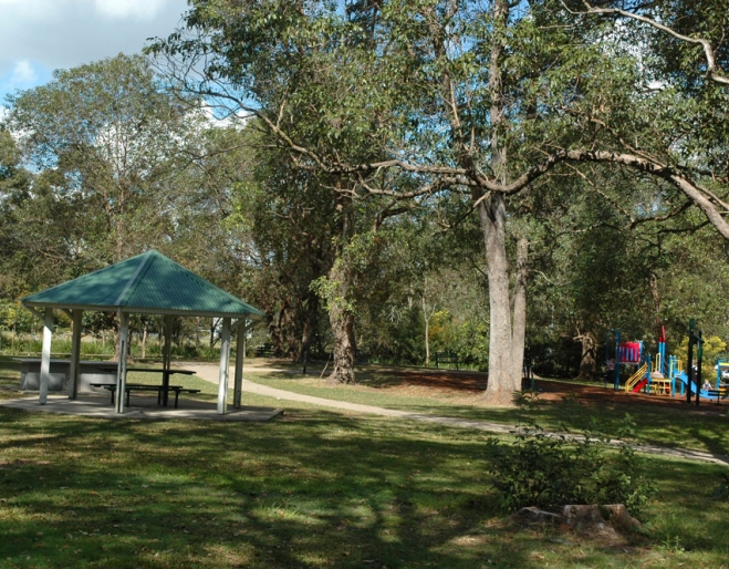 Picnic shelter and kinds plaground inside Bowman Park in Bardon