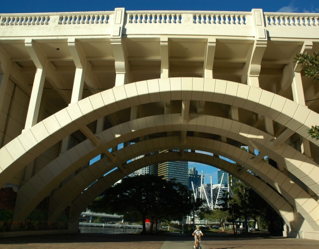 Kid cycling under Jolly Bridge 