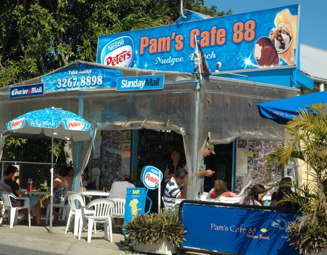 Peopel sitting on terrace outside Pam's Cafe in Nudgee Beach 