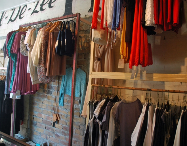 Clothes rack and original store sign on wall inside Atrium in Sandgate