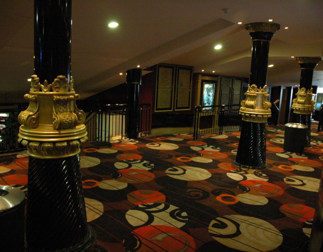 Foyer with columns and coloured carpet inside the Balmoral Cinema in Bulimba
