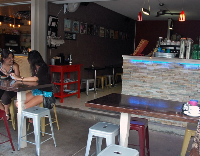 Couple sitting at table in front of bar at Buzzstop Espresso Bar in Samford