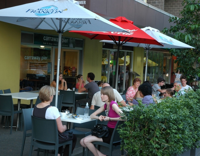 People eating fish and chips outside Carraway Pier Fish & Chips, Kelvin Grove