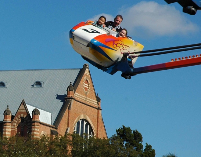 Kids on joyride at the Ekka with the Old Museum in the background