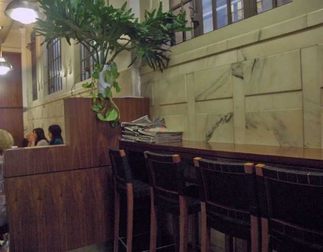 Seating area and marble walls inside Extract Espresso.