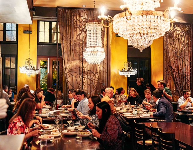 Diners at table inside of Libertine 