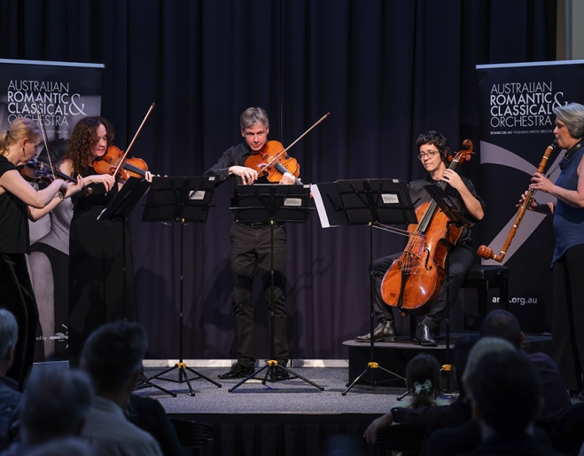 ARCO Orchestra performing on stage 