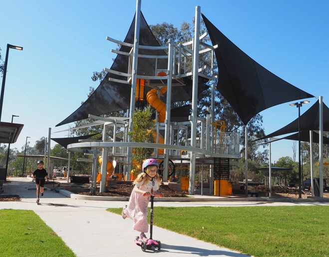 Child playing in playground, Archerfield Wetlands District Park