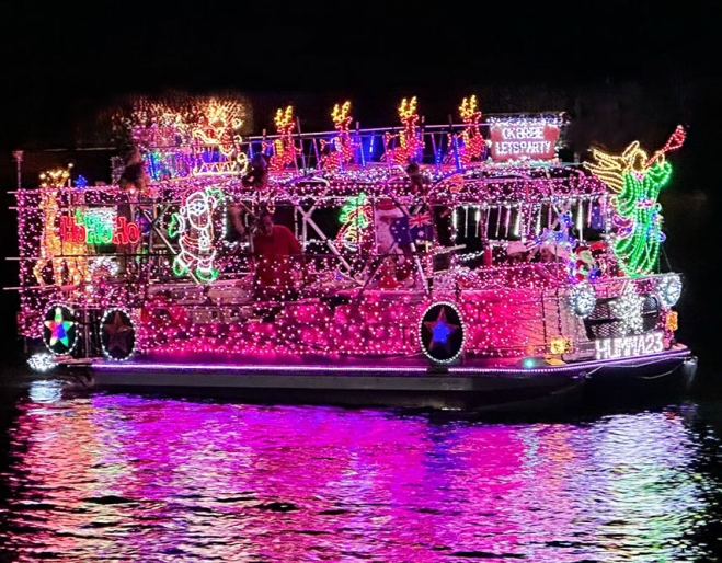 Boat lit up with pink Christmas lights on Bribie Island