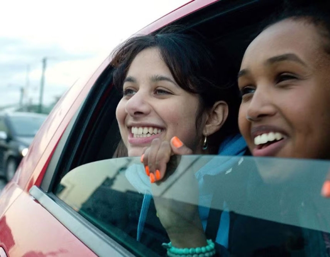 Scene of two women smiling and looking out a car window in Brides movie at the Brisbane International Film Festival 2025