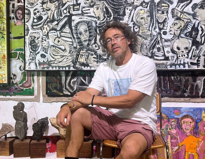 Carlos Barrios in front of his art pieces at his ‘Heart Songs’ Exhibition at Mitchell Fine Art