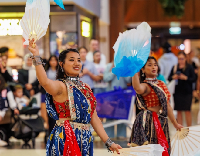 two ladies do a traditional dance
