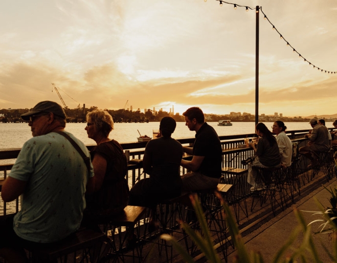 People sitting along river