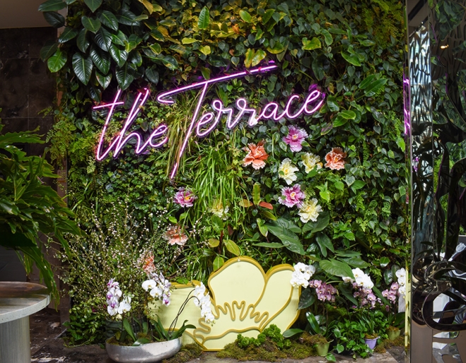 Flowers outside The Terrace sign at Sky High Champagne Hour at the Emporium Hotel