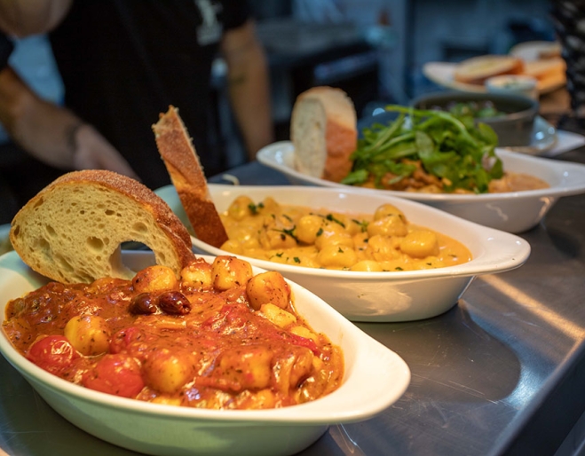 Dishes of gnocchi on table