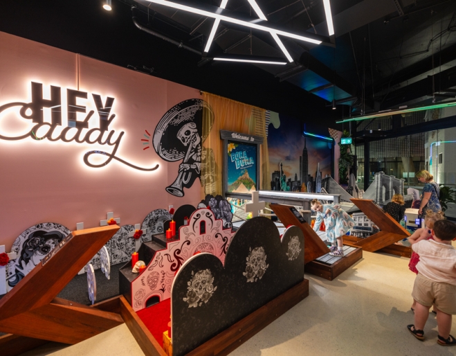 Interior of X-Golf South Bank showing children playing a game