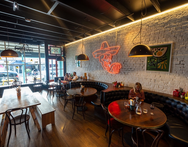 People sitting at tables inside La Carmela Petrie Terrace