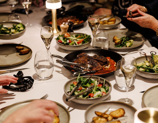 Diners at a table inside Lamberts Restaurant