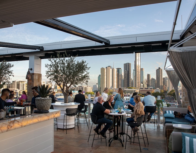 People sitting at rooftop bar at MAYA Mexican Restaurant & Bar