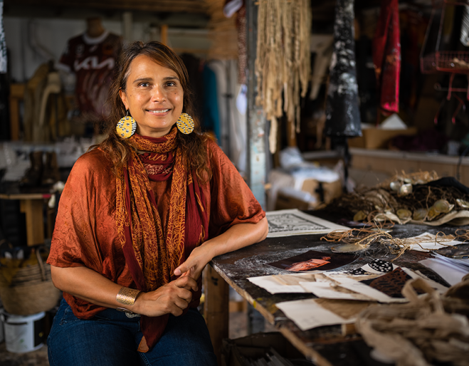 Artist Delvene Cockatoo-Collins sitting in her studio