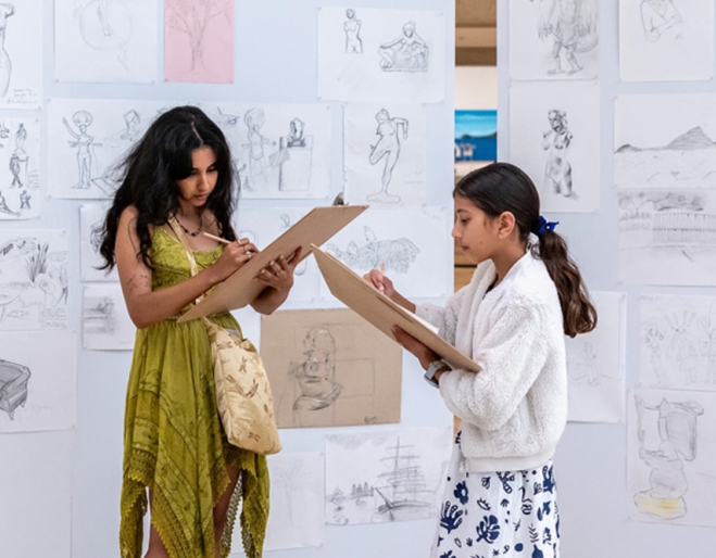 Two people drawing