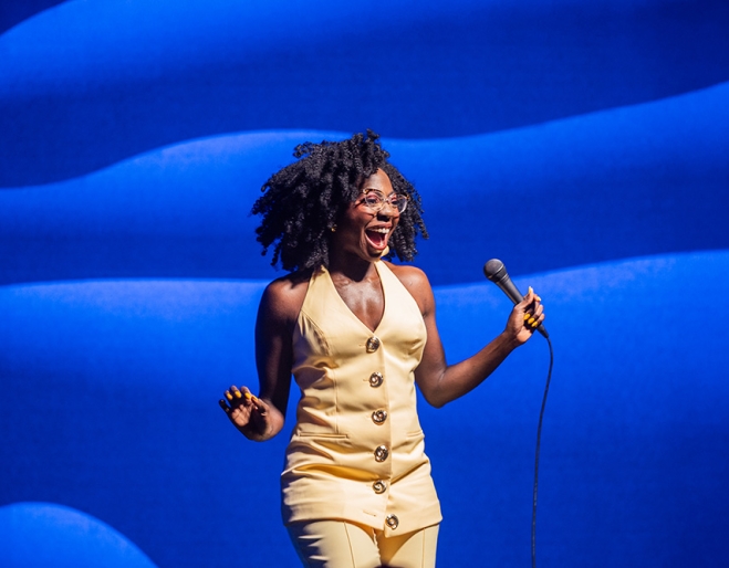 Anisa Nandaula on stage performing her stand up show