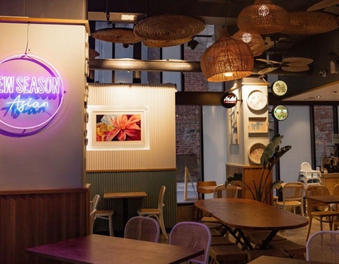 Tables and chairs inside New Season Asian, Brisbane at night