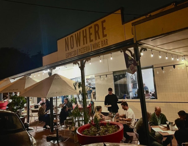 Exterior of Nowhere Espresso & Bar by night
