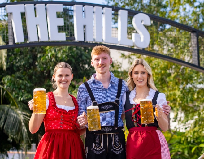 People holding beers at Oktoberfest at The Hills