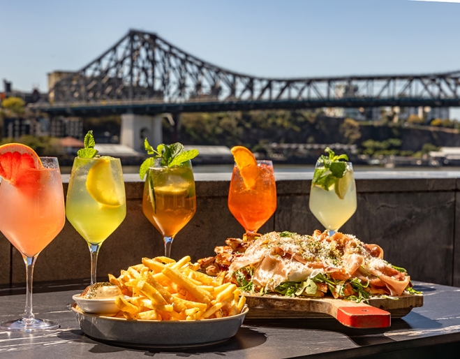 Cocktails and food in front of the Story Bridge