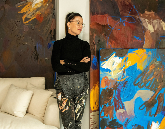 women standing in front of artwork 