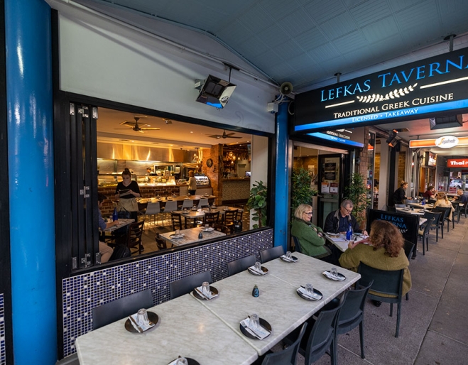 People dining at tables outside Lefkas Taverna West End