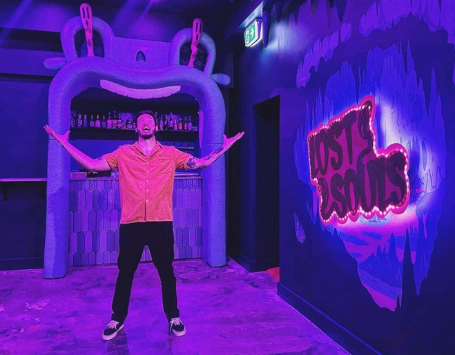 Man with arms raised inside Lost Souls Karaoke Fortitude Valley