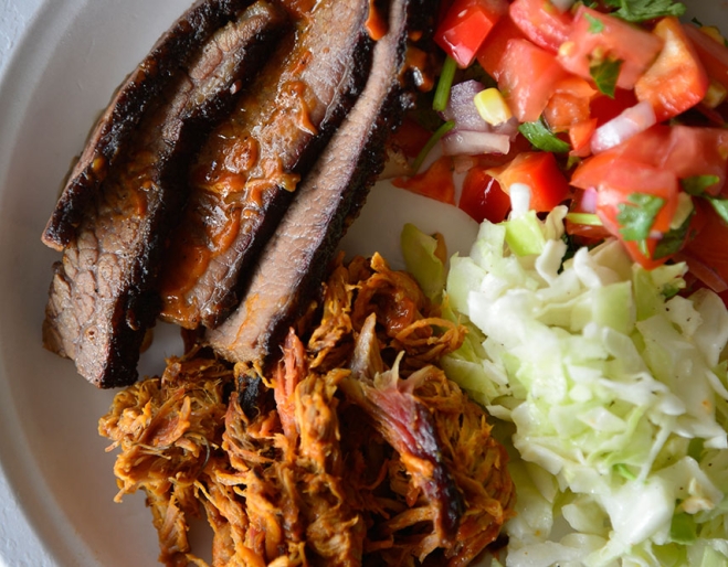 Meat and salad on a plate at Bluegrass BBQ Smokehouse at Hudson Corner