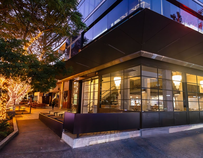 Exterior lit up Facade of Petite Restaurant