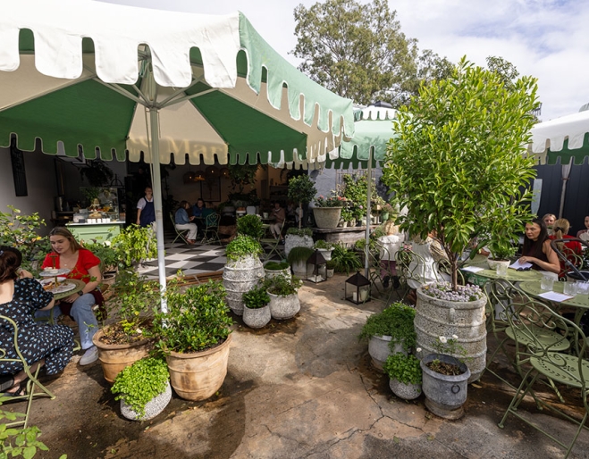 People seated in garden at Tarte Tea Garden