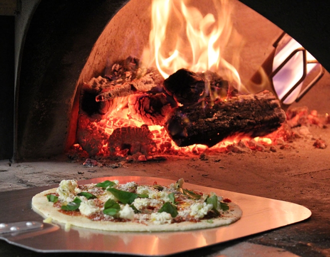 Pizza on a tray outside wood-fired pizza oven at Pizzeria 1760 Yeronga