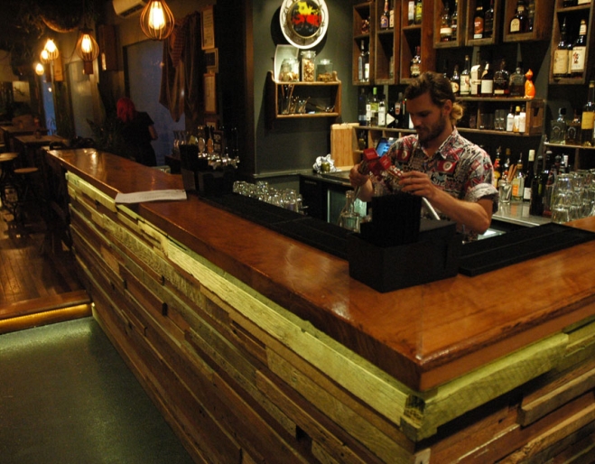 Barman mixing drinks at bar insideThe End Bar in Brisbane's West End 