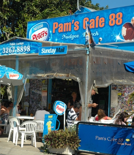 Peopel sitting on terrace outside Pam's Cafe in Nudgee Beach 