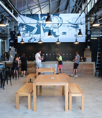 Bench seating and people standing at the bar at Ballistic Beer Co Salisbury