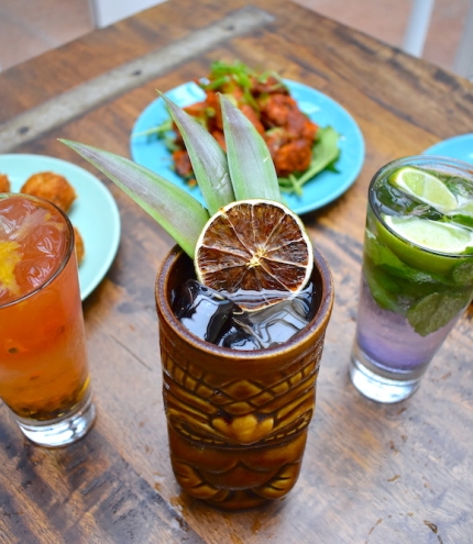 Drinks in glasses and three plates of food at Barbossa Bar & Bottleshop
