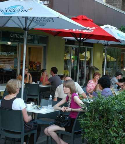 People eating fish and chips outside Carraway Pier Fish & Chips, Kelvin Grove