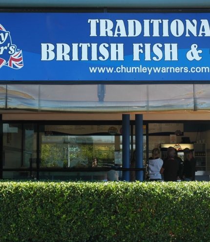 Chumley Warner's British Fish & Chips, Birkdale, shopfront with hedge in front of it