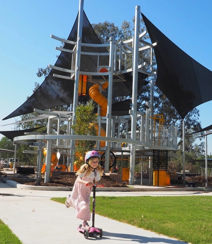 Child playing in playground, Archerfield Wetlands District Park