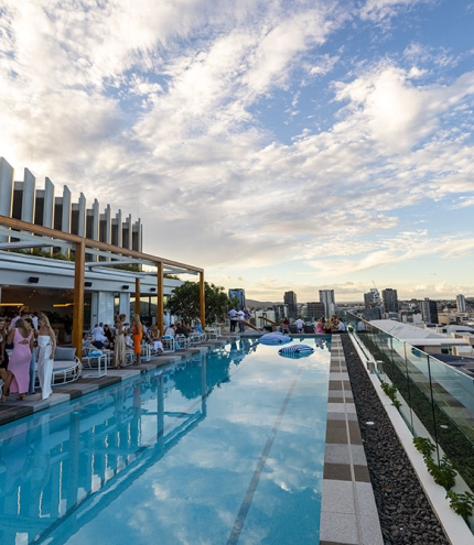 Pool with people siting on Lina Rooftop, South Brisbane 