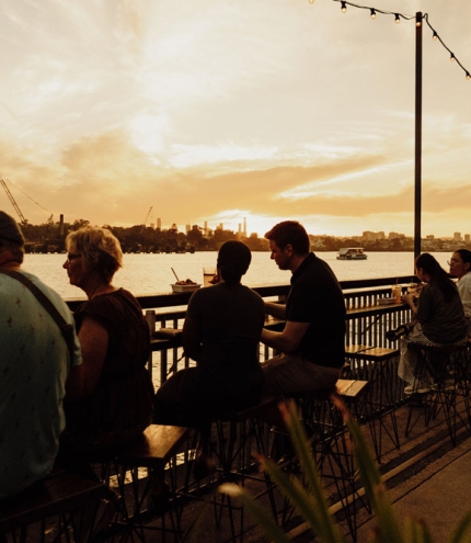 People sitting along river