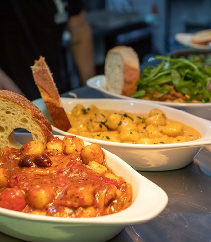 Dishes of gnocchi on table