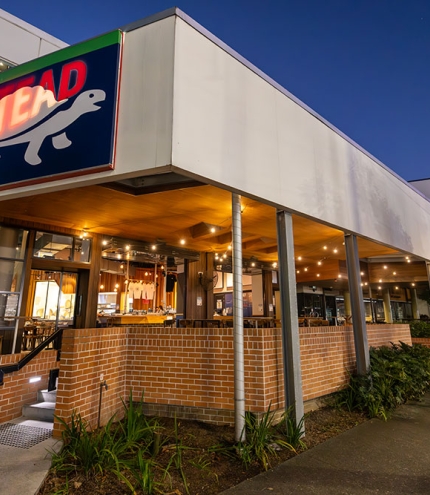 Exterior corner with lit up sign Last Man Standing